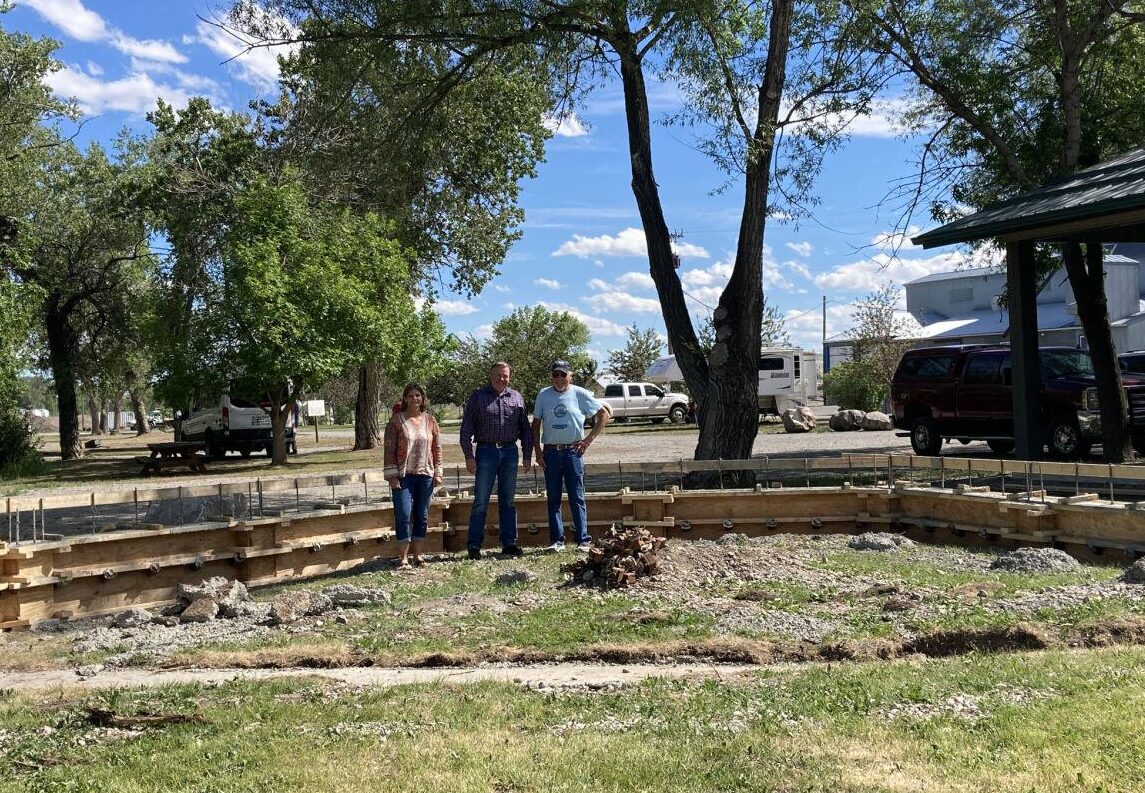 First Bank of Montana-Choteau Vice President Karrie Crabtree and President Lyle Hodgskiss stand with Choteau Lions Club member Rich Clough last week at the site of the new permanent band shell being built this summer with a major $20,000 from the bank to start the project rolling. Acantha photo by Melody Martinsen